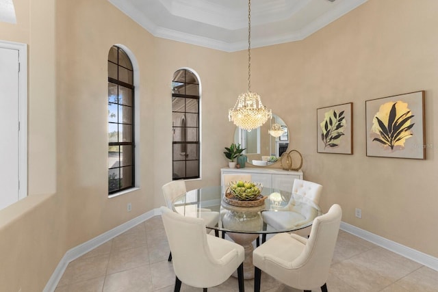 tiled dining area featuring a tray ceiling, crown molding, and a high ceiling