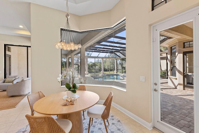 dining area featuring a towering ceiling and light tile patterned floors