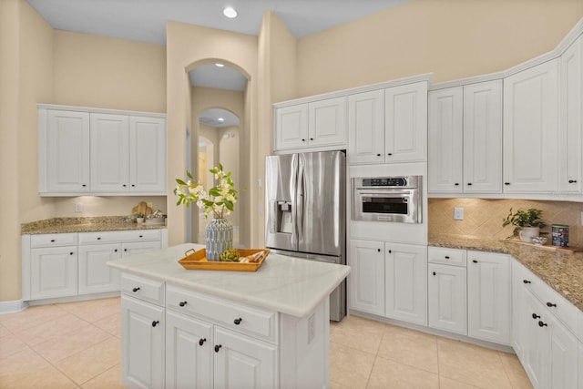 kitchen featuring white cabinetry, appliances with stainless steel finishes, and light tile patterned floors