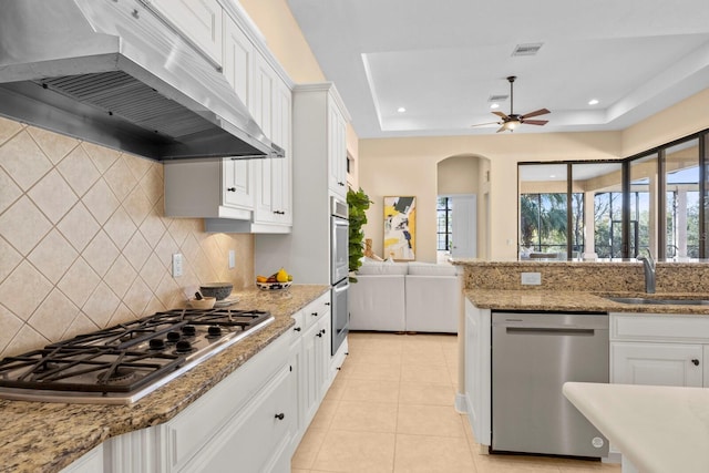 kitchen with white cabinetry, appliances with stainless steel finishes, sink, and extractor fan