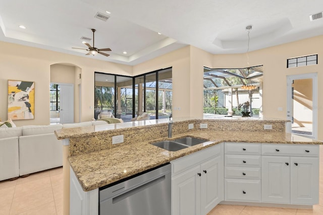 kitchen with white cabinetry, sink, a tray ceiling, and dishwasher