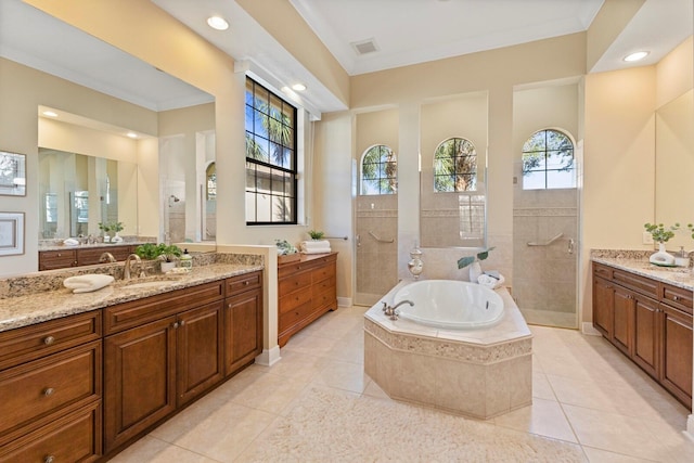 bathroom featuring tile patterned floors, ornamental molding, plus walk in shower, and vanity