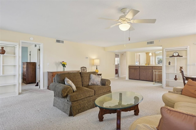 living room with ceiling fan and light colored carpet