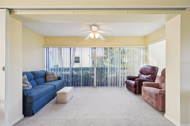 living room with ceiling fan, carpet floors, and a healthy amount of sunlight