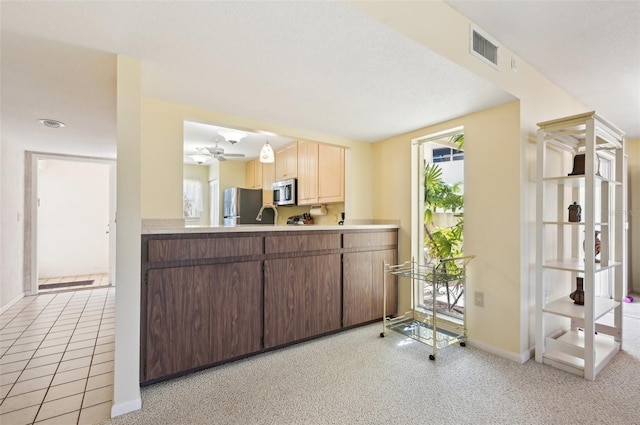 kitchen with ceiling fan, light carpet, and appliances with stainless steel finishes