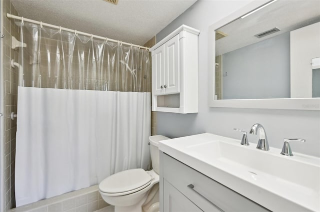 bathroom featuring vanity, a textured ceiling, toilet, and a shower with shower curtain