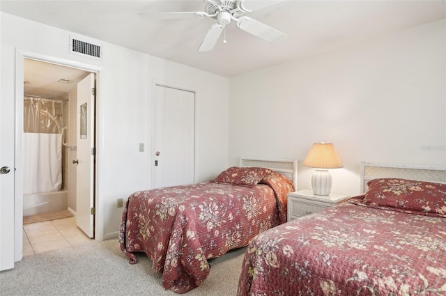 carpeted bedroom with ceiling fan and connected bathroom