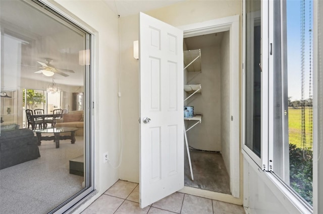 bathroom featuring ceiling fan and tile patterned flooring