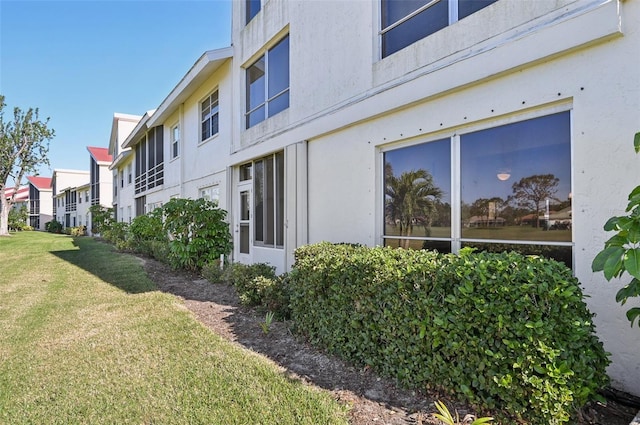 view of side of property with a lawn