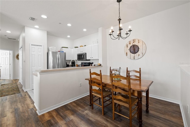 dining room with a notable chandelier and dark wood-type flooring