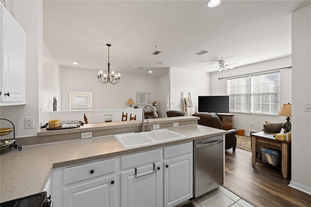 kitchen with ceiling fan with notable chandelier, sink, decorative light fixtures, dishwasher, and white cabinets