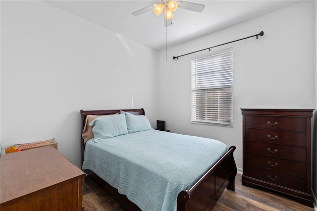 bedroom with ceiling fan and dark wood-type flooring