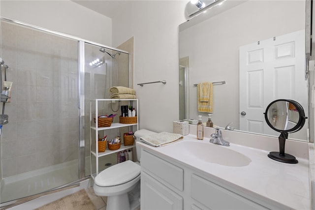 bathroom featuring tile patterned floors, vanity, toilet, and an enclosed shower