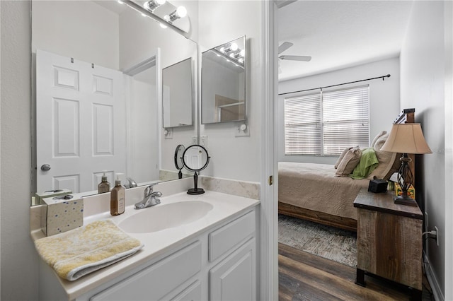 bathroom with wood-type flooring, vanity, and ceiling fan