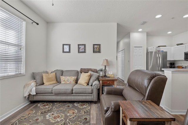 living room with dark hardwood / wood-style flooring