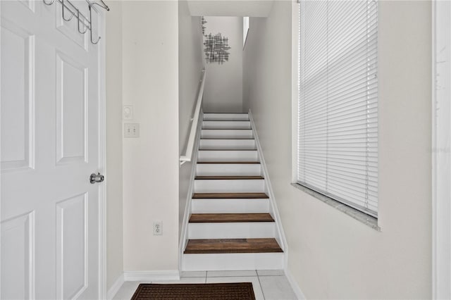 stairs featuring tile patterned floors