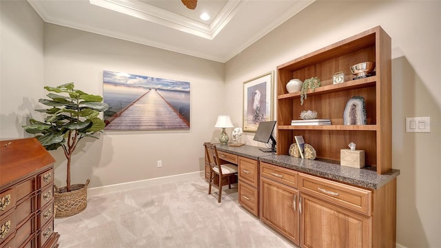 carpeted office with crown molding and built in desk