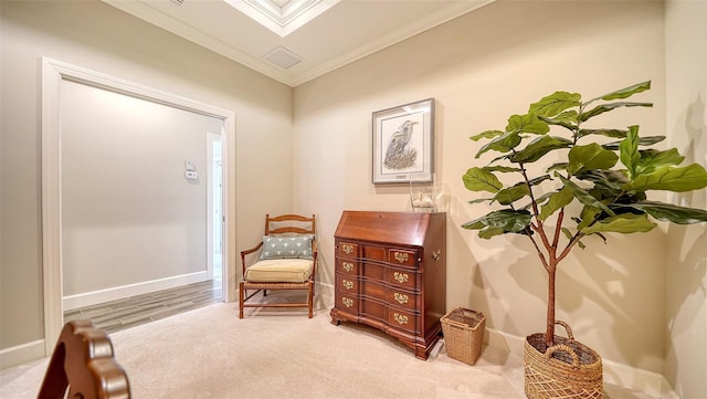 sitting room with light colored carpet and crown molding