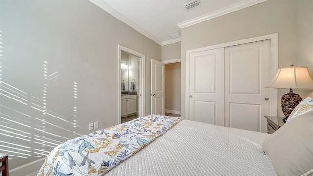 bedroom with ensuite bath, ornamental molding, and a closet