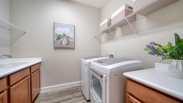 laundry area with cabinets, sink, and washer and dryer