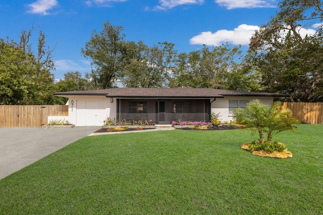 ranch-style home featuring a garage, fence, driveway, stucco siding, and a front lawn