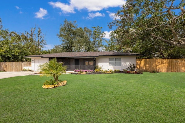 single story home with a garage, a front yard, driveway, and fence