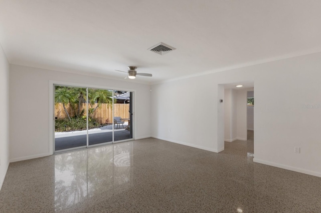 spare room with visible vents, ceiling fan, baseboards, and speckled floor