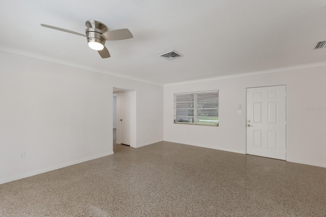 empty room featuring ceiling fan, speckled floor, visible vents, and baseboards