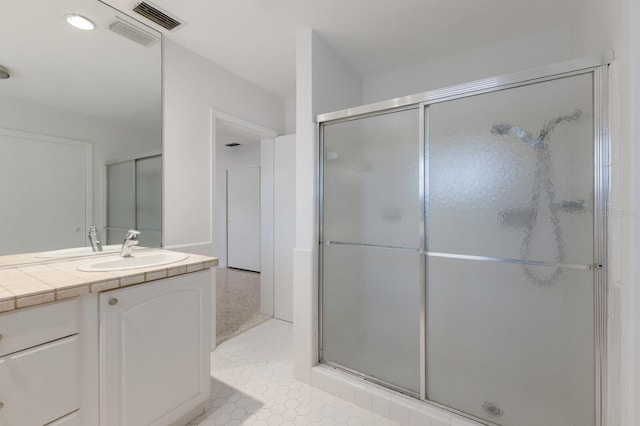 bathroom with vanity, visible vents, and a shower stall