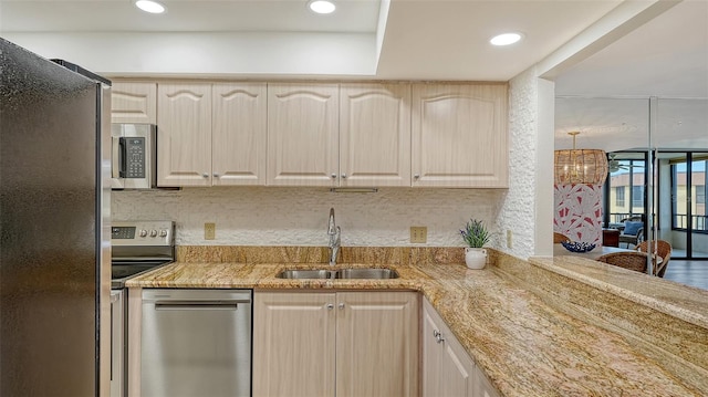 kitchen with light brown cabinetry, sink, and stainless steel appliances