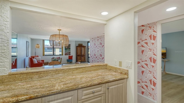 bathroom featuring hardwood / wood-style floors, vanity, and an inviting chandelier