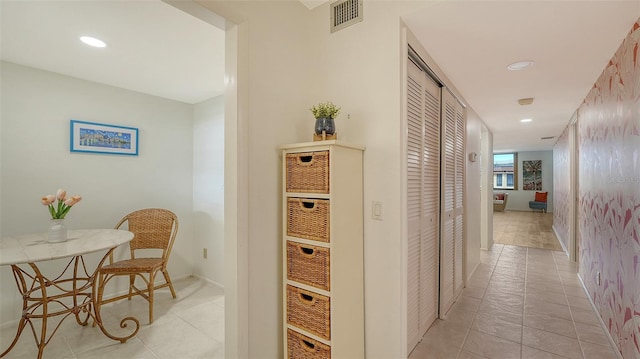 hall featuring light tile patterned flooring