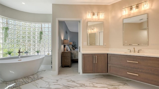 bathroom with vanity and a tub