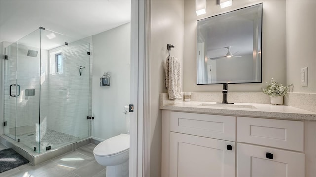 bathroom featuring toilet, an enclosed shower, vanity, ceiling fan, and tile patterned flooring