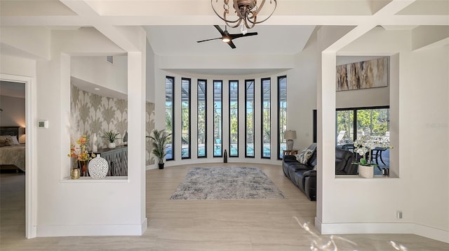 foyer entrance with coffered ceiling, beam ceiling, and ceiling fan