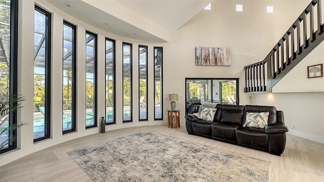 living room featuring high vaulted ceiling