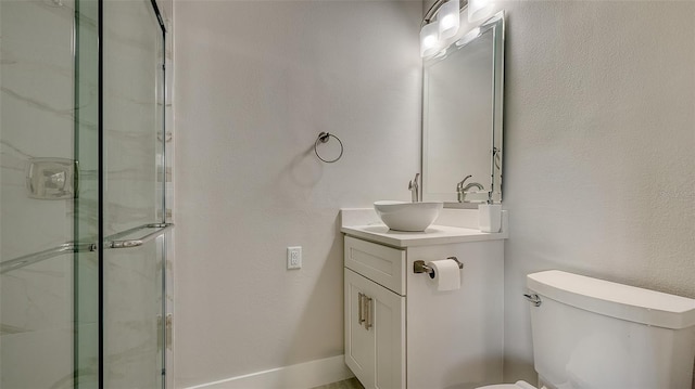 bathroom with vanity, toilet, and an enclosed shower