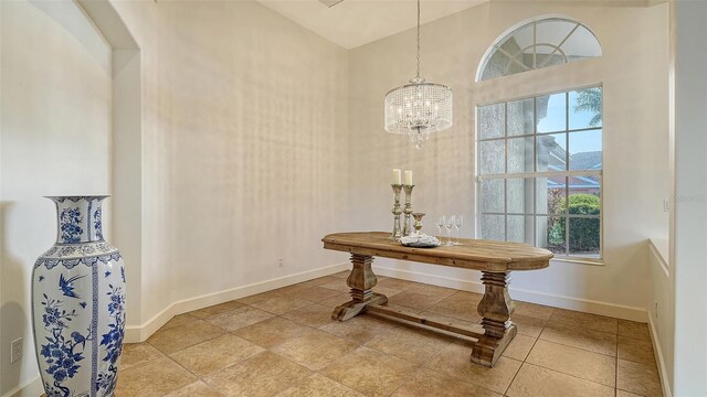 interior space with a high ceiling and an inviting chandelier