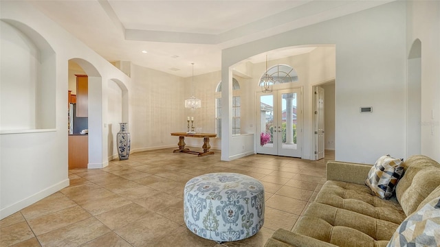 interior space featuring french doors and an inviting chandelier