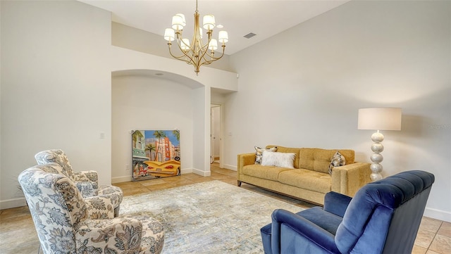 tiled living room featuring a notable chandelier