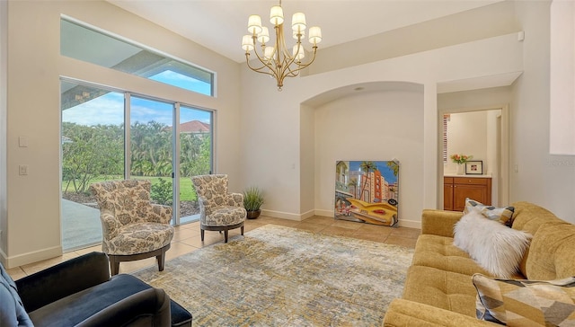 tiled living room featuring a chandelier