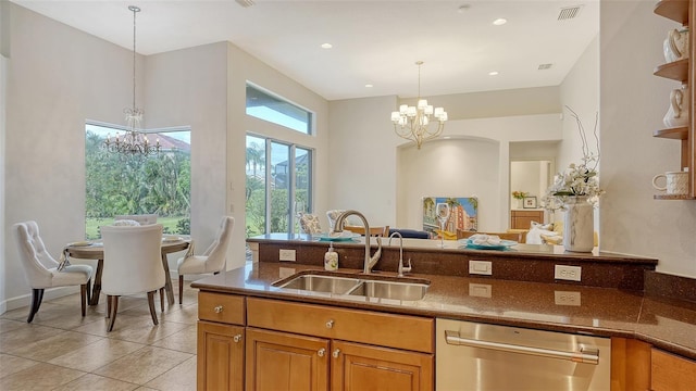 kitchen with sink, light tile patterned floors, decorative light fixtures, an inviting chandelier, and dishwasher