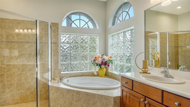 bathroom featuring vanity and independent shower and bath