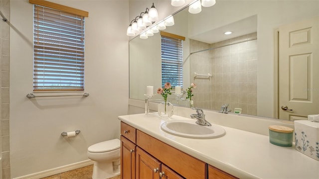 bathroom with tiled shower, tile patterned floors, vanity, and toilet