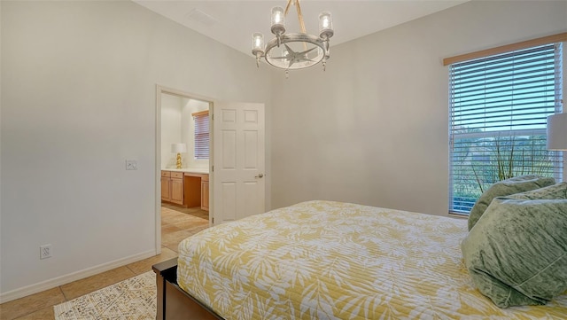 bedroom with a chandelier and light tile patterned floors