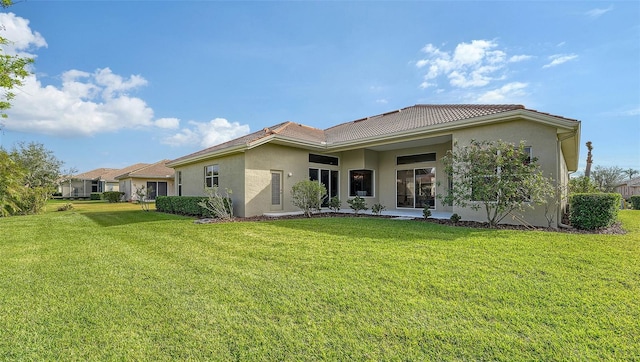 rear view of property featuring a yard