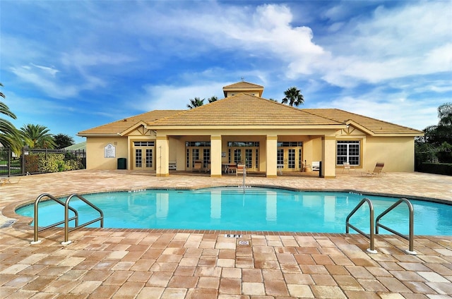 view of swimming pool with a patio area and french doors