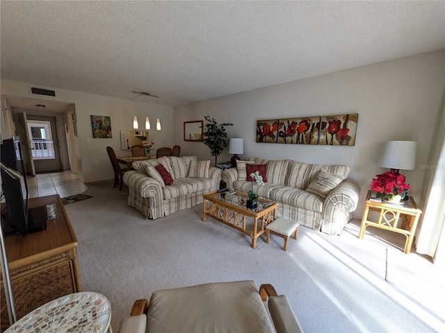 carpeted living room with a textured ceiling