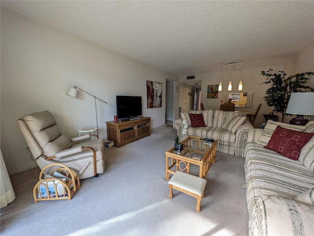 carpeted living room featuring a textured ceiling