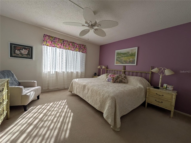 bedroom with carpet flooring, ceiling fan, and a textured ceiling